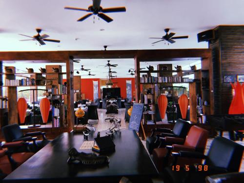a room with tables and chairs and ceiling fans at The Island Lodge in My Tho