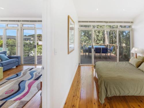 a bedroom with a bed and a living room at Lewis Retreat 40 Lewis Road in Carrickalinga