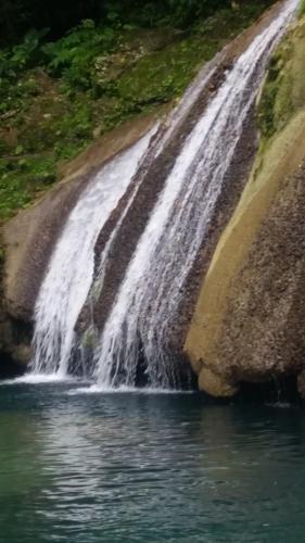 a waterfall on the side of a river at Mack's Home in Clifton