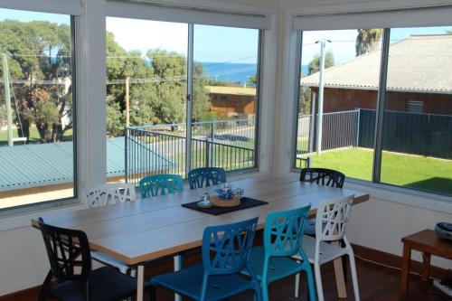 a large screened in porch with a table and chairs at The Beach Shack - OCEAN VIEWS, CLOSE TO THE BEACH in Guilderton