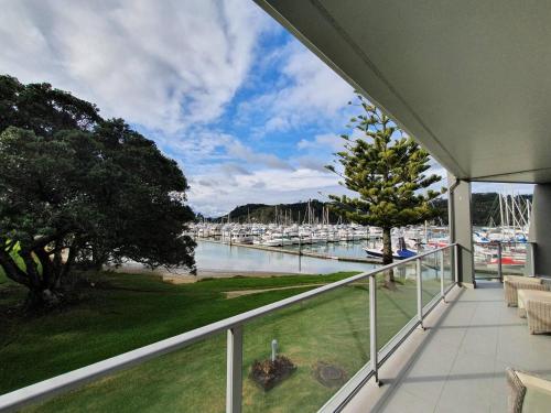 a balcony with a view of a marina with boats at Marina Park Apartments Whitianga in Whitianga