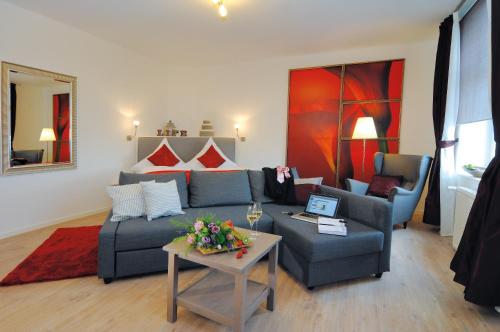 a living room with a couch and a table at Landhaus Heidekrug in Hildesheim