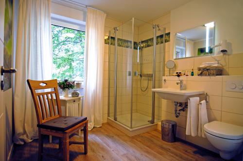 a bathroom with a shower and a sink and a toilet at Landhaus Heidekrug in Hildesheim