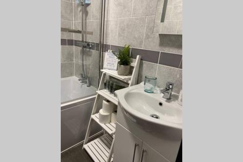 a bathroom with a sink and a shower and a tub at The Garden Apartment with Hot Tub - Westbrook Bay Beach - By Goldex Coastal Breaks in Kent