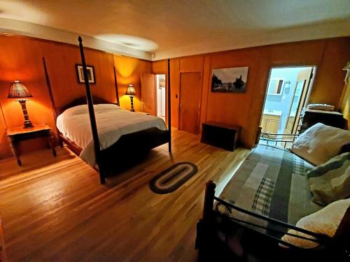 a bedroom with a bed and a living room at Brown's Beach at Schroon Lake in Schroon Lake