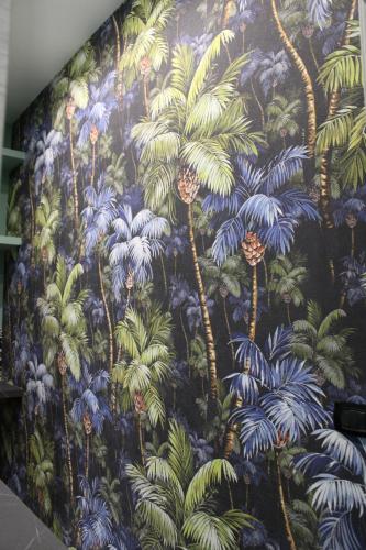 a mural of palm trees on a wall at i Giardini di Rita- Rooms & Garden Loft in Margherita di Savoia