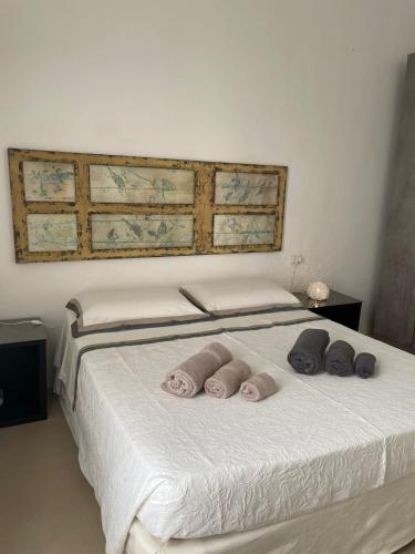 a bedroom with a bed with three pillows on it at La Casa di Bacco B&b in Alezio