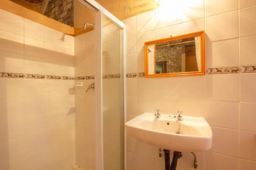 a bathroom with a sink and a shower at SERENITY Du Bois Lodge in Marloth Park