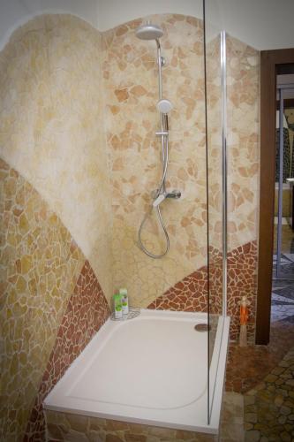 a shower with a glass door in a bathroom at Hotel Bojnický vínny dom in Bojnice