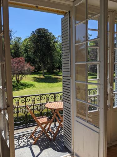 an open door to a balcony with a picnic table at Chateau de La Faye in Ménétréol-sur-Sauldre