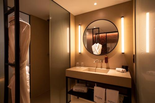 a bathroom with a sink and a mirror at Hotel Paxton Barcelona in Barcelona