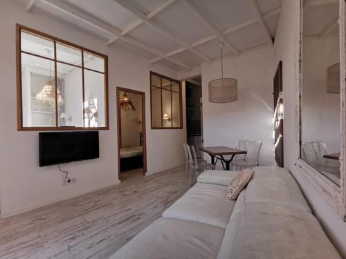 a living room with a couch and a table at Jardin Vieux Port Panier in Marseille