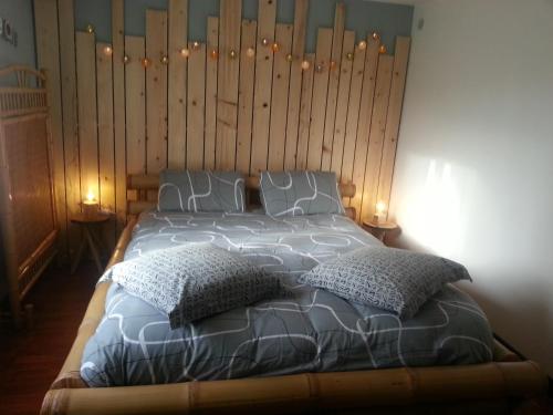 a bedroom with a large bed with two pillows at LES HERISSONS in Étricourt-Manancourt