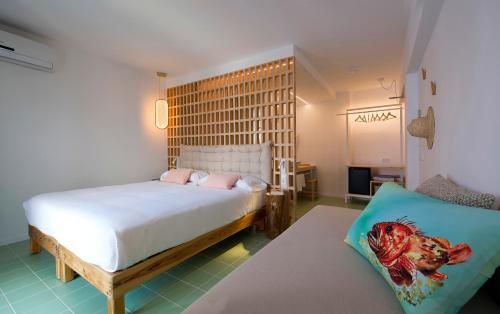 a bedroom with a bed and a couch in it at Hostal Boutique Cana Rita in San Antonio