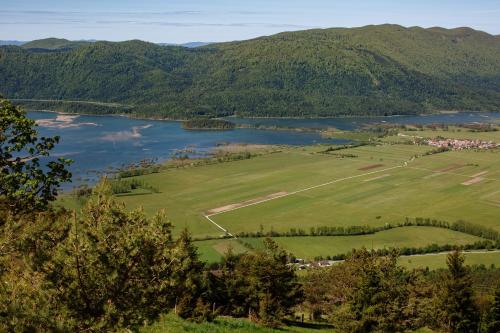 an aerial view of a field and a lake at Dom na Slivnici in Cerknica