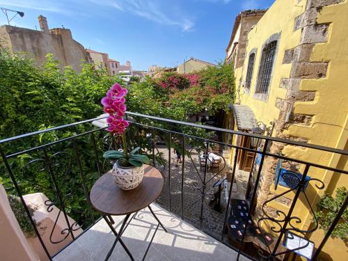 a vase of flowers sitting on a table on a balcony at Casa Dasyra in Chania Town
