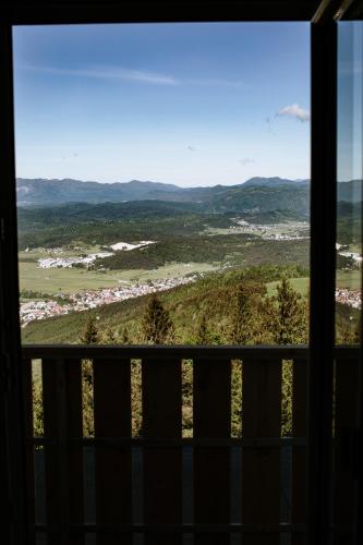 a view of a valley from a window at Dom na Slivnici in Cerknica