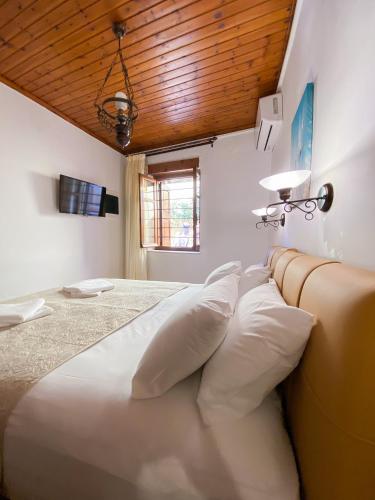 a bedroom with a large bed with white pillows at Casa Dasyra in Chania Town