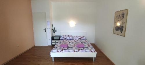a bedroom with a bed with shoes on it at Sea breeze Apartments with boat Anchorage in Stara Novalja