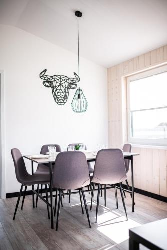 a dining room with a table and chairs at Silva in Rewal