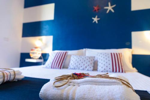 a bedroom with two beds and a blue wall with stars at Villa Curiazzi Guesthouse Viale la Pelosa 16 in Stintino