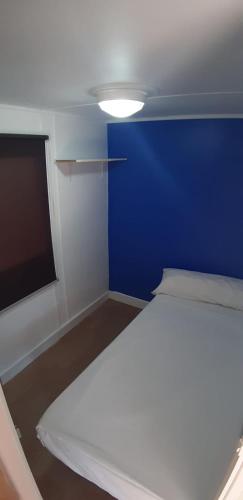 a small room with a blue wall and a bed at Camping Cases in Les Cases d'Alcanar