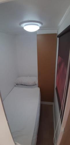 a small room with a bed and a light at Camping Cases in Les Cases d'Alcanar
