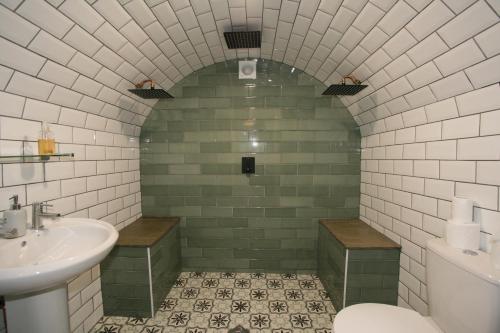 a bathroom with a sink and a toilet at Albion Street Serviced Apartments in Cheltenham