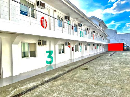 a large white building with the number six on it at Islands Stay Hotels Mactan in Mactan