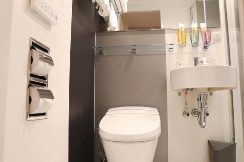a small bathroom with a toilet and a sink at Hotel The M's Kyoto in Kyoto