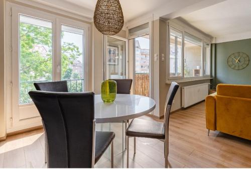 une salle à manger avec une table et des chaises dans l'établissement L'austerlitz, T2 au coeur de Strasbourg, à Strasbourg