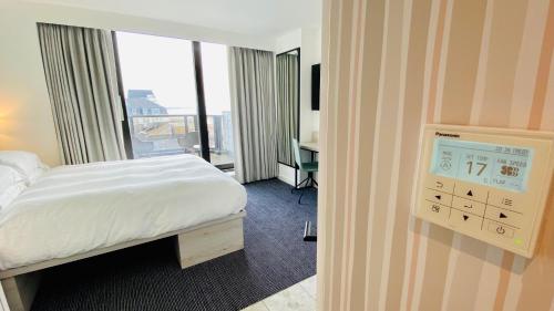a hotel room with a bed and a clock on the wall at The View Hotel in Eastbourne