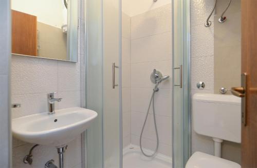a bathroom with a shower and a sink and a toilet at Apartments Marijan 105 in Pula