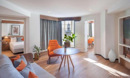 a living room with a couch and a table at Melia White House Hotel in London