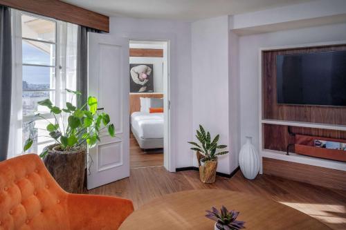 a room with a bedroom with a bed and a television at Melia White House Hotel in London