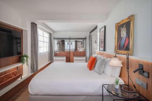 a bedroom with a large bed and a television at The Level at Melia White House in London