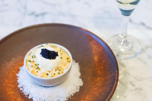 a plate with a bowl of food on top of sugar at Meliá White House Hotel Apartments in London