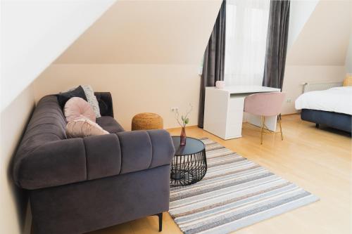 a living room with a couch and a bed at Villa Lieboch in Lieboch