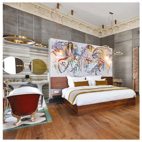 a bedroom with a large bed and a bath tub at Hotel The Public - Special Category in Istanbul
