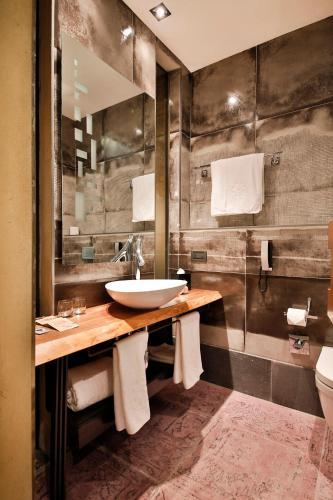 a bathroom with a sink and a mirror at Hotel The Public - Special Category in Istanbul