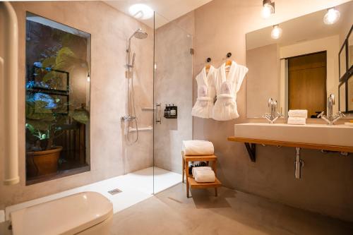 a bathroom with a shower and a sink and a toilet at Hotel Margot House Barcelona in Barcelona