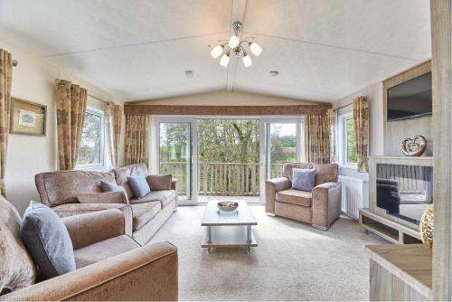 a living room with a couch and chairs and a table at Host & Stay - Yolo Lodge in Felton