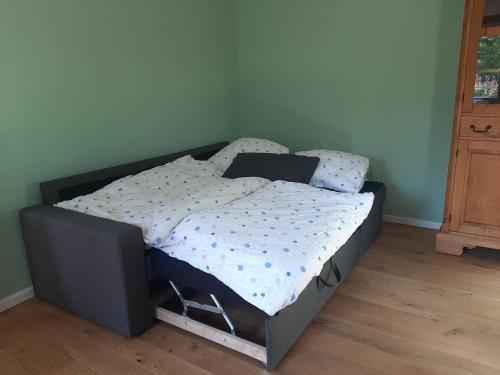 a bed with a black frame in a bedroom at Waldurlaub Klingelborn im Sauerland in Balve