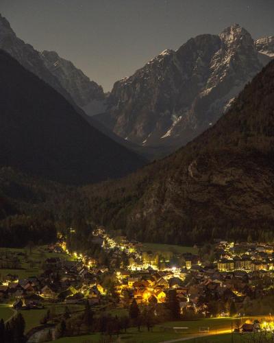 a small town in the mountains at night at Country house Dovje in Dovje