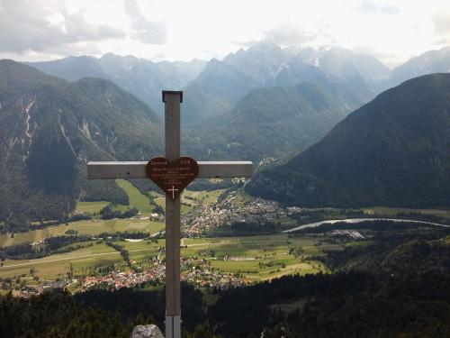 a wooden cross on top of a mountain at Country house Dovje in Dovje