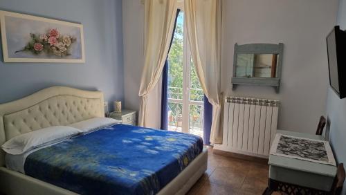 a bedroom with a bed and a large window at Antico Borgo Piceno in Ascoli Piceno