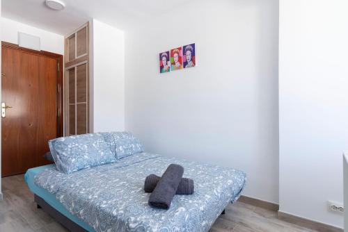 a bedroom with a bed with two black objects on it at Panoramic views cosy studio in Benalmádena