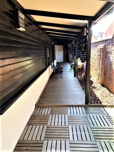 a wooden walkway with benches in a building at Star Apartment Ipswich, A Hidden Gem near the Waterfront in Ipswich