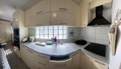 eine Küche mit weißen Schränken und einer Arbeitsplatte in der Unterkunft SunRise Apartament in Mangalia