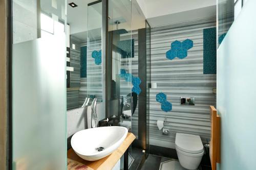 a bathroom with a white sink and a toilet at Hotel The Public - Special Category in Istanbul